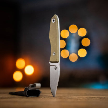 Lookout knife with Green Micarta handle displayed upright beside a Kydex sheath
