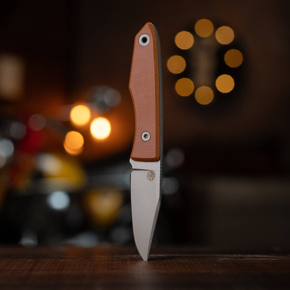 USA Lookout knife with Natural Micarta handle displayed upright on a wooden table

