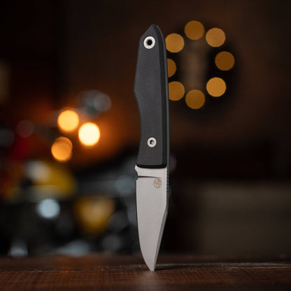 USA Lookout knife with Black G10 handle displayed upright on a wooden table
