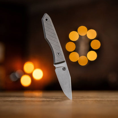 USA Lookout drop-point knife with grooved titanium handle displayed on a wooden table
