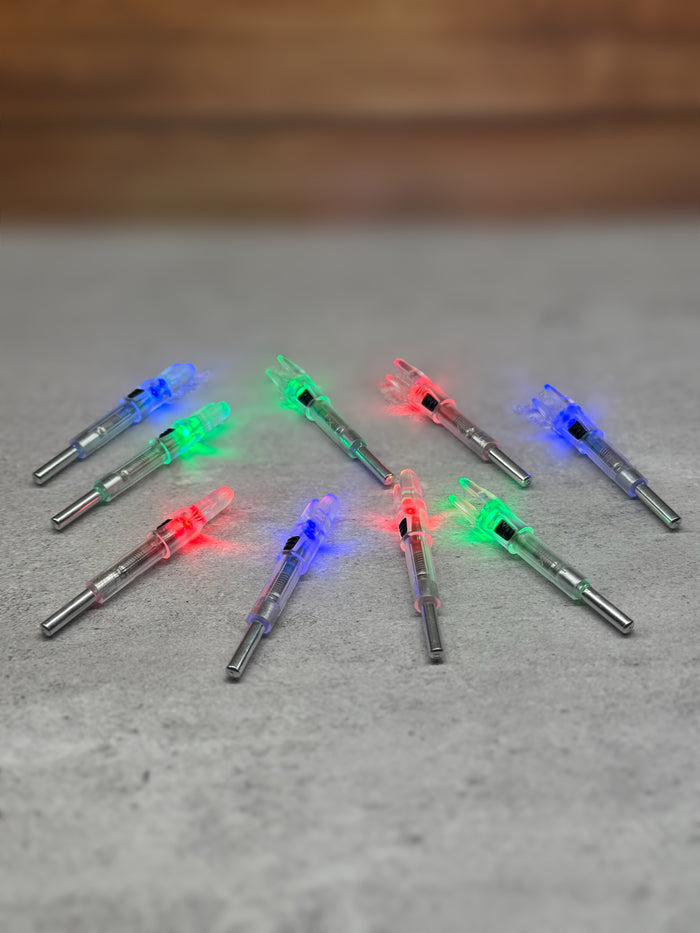 EZ On/Off lighted arrow nocks glowing blue, red, and green on a gray surface