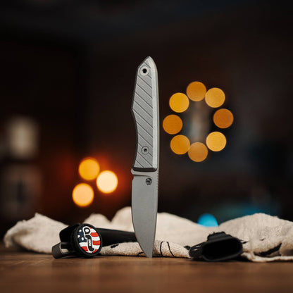 Lookout knife with Black G10 handle displayed beside two Kydex sheaths
