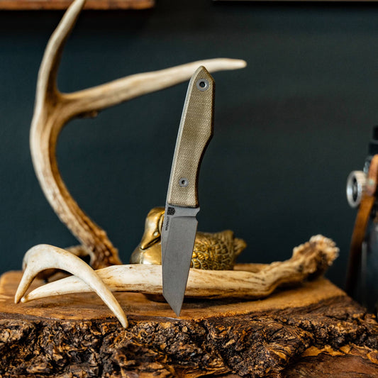 Antlers: Big Idea Design Lookout reverse tanto knife with green Micarta handle displayed among antlers