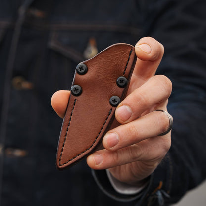 Sheath front: Front of the Lookout brown leather sheath held in hand, showing stitching and black hardware