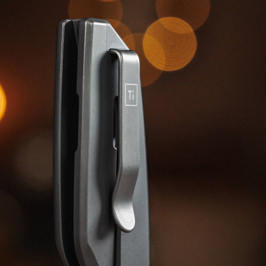 Close-up of the Ti Manu titanium deep-carry pocket clip on the closed knife