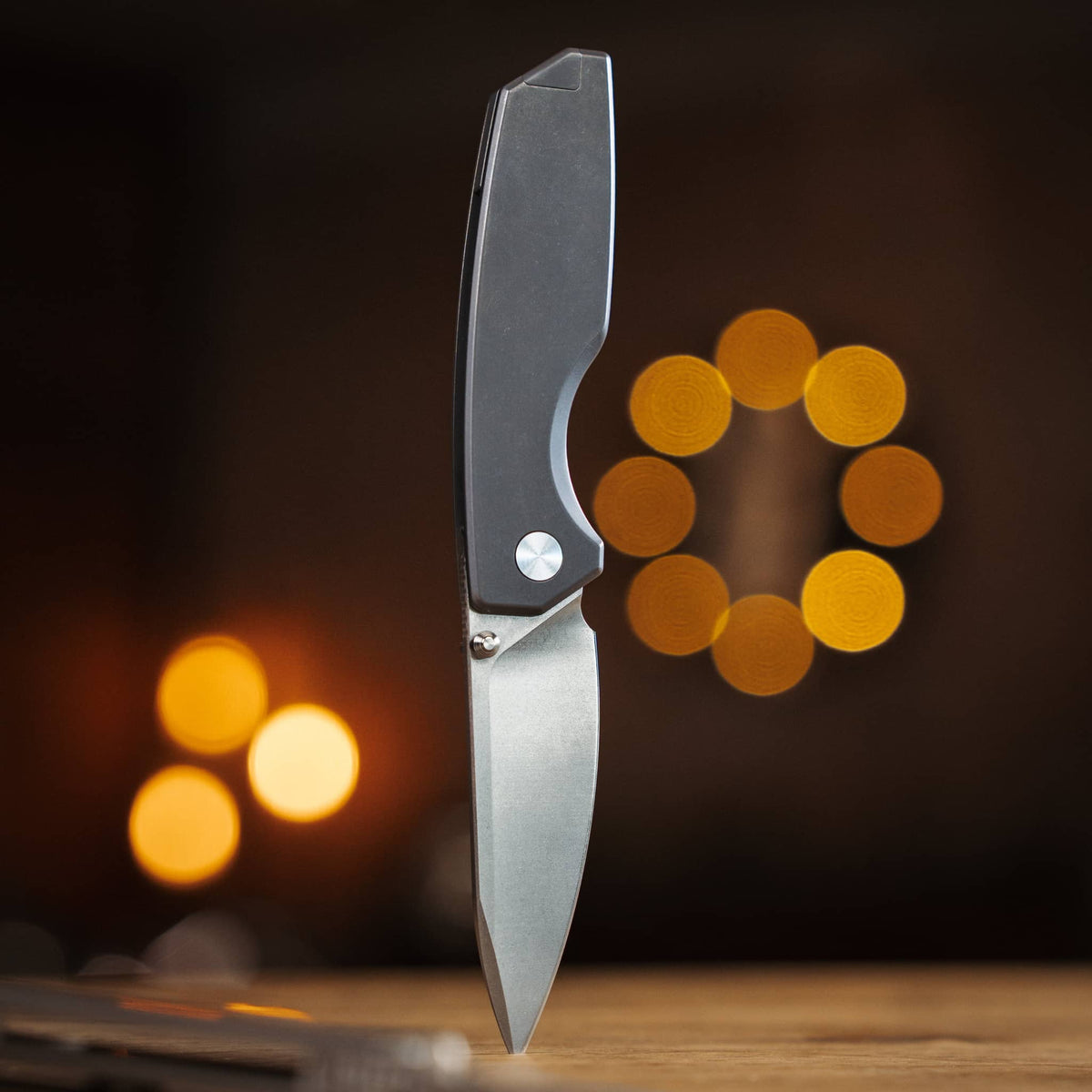 Big Idea Design Ti Manu knife displayed open, showing the blade and titanium handle